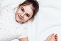 Top view on cute brunette girl lying on bed. Royalty Free Stock Photo