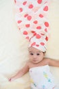 Top view of a cute little Asian baby with a hair towel and a towel wrapped around her body after taking shower Royalty Free Stock Photo
