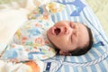 Top view of cute little Asian baby yawning Royalty Free Stock Photo