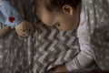 top view Cute little chubby baby girl kid sleeping sweetly in grey crib during lunch rest time in white and pink pajamas Royalty Free Stock Photo