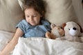 Top view cute little girl sleeping with favorite toys