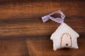 Cute stripped stuffed toy in a shape of house on a wooden background