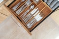 Cutlery set in bamboo trays in kitchen drawer Royalty Free Stock Photo