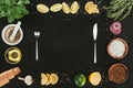 top view of cutlery and various spices and seasonings on black Royalty Free Stock Photo