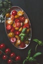 top view of cutted red and yellow cherry tomatoes in metal plate Royalty Free Stock Photo