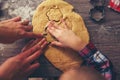 Top view of cutting gingerbread of metal molds by children's han