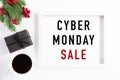 Top view of Cyber Monday Sale text on white picture frame with coffee cup, gift box and Christmas tree decoration, red berries on Royalty Free Stock Photo