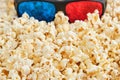 Top view of 3d glasses on crunchy popcorn, cinema concept