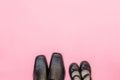 Top view daddy boots with daughter girl child on pink background