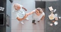 Top view dancing and senior couple in kitchen having fun, bonding and enjoy retirement together. Love, romance and Royalty Free Stock Photo