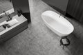 Top view of dark bathroom interior with sink and mirror, tub and table