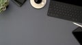 Top view of workspace with copy space, digital tablet, smartphone, office supplies and coffee cup on grey table Royalty Free Stock Photo