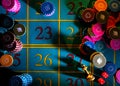 Top view of a dark poker table with chips and dice for playing poker. Poker colored chips and dice close up. Gambling Royalty Free Stock Photo