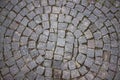 Top view dark square stones stacked on the ground in a circle.