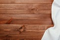 Top view on a dark wooden table with a linen kitchen towel or textile napkin. a tablecloth on a countertop made of old wood Royalty Free Stock Photo