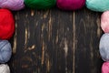 Top view of dark wooden table with skeins of different colors Royalty Free Stock Photo