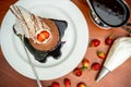 Top view of a decorated tiramisu cake with strawberries.