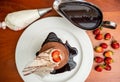 Top view of a decorated tiramisu cake with strawberries.