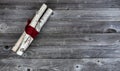 Top view of decorated white birch logs wrapped in red cloth on age wooden planks for a Merry Christmas background Royalty Free Stock Photo