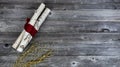 Top view of decorated white birch logs wrapped in red cloth and golden flaming decorations on age wooden planks for a Merry Royalty Free Stock Photo