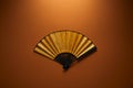 Top view of decorative black and golden fan with hieroglyphs