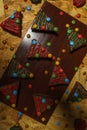 Top view of decorative Christmas tree biscuits on a wooden board