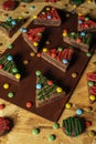 Top view of decorative Christmas tree biscuits on a wooden board