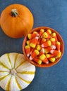 Top view of decorative Halloween pumpkins and bright orange, yellow and white candy corn, a traditional American seasonal sweet. Royalty Free Stock Photo