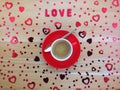 Top of view of decorative red hearts near cup of coffee on wooden table