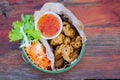 Top view deep fried chicken tendons with salad and carrot on wood table background