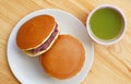 Top View of Dorayaki with a Cup of Hot Matcha Green Tea