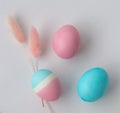 Top view. Delicate colors of Easter eggs on a white table