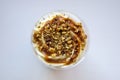 Top view of delicate sweet dessert made of sponge dough, chocolate, crushed walnut kernels and custard. Delicious desserts