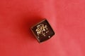 Top view of delicious Belgium chocolate on a red background