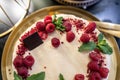 Top view. Delicious berry cake with red raspberries, strawberries, lingonberries and mint leaves. Royalty Free Stock Photo