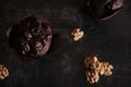 Top view of a delicious chocolate muffin and walnuts on a dark-colored table Royalty Free Stock Photo