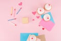 Top view of delicious cupcakes, colorful candles and hearts symbols on pink Royalty Free Stock Photo
