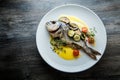 top view on delicious fried fish served with sliced vegetables Royalty Free Stock Photo