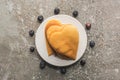 Top view of delicious heart shaped pancakes on plate near blueberries on grey concrete surface Royalty Free Stock Photo
