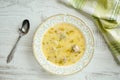 Top view of delicious, homemade, traditional bulgarian chicken soup pileshka chorba with egg thickener on a rustic wooden table Royalty Free Stock Photo