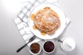 Top view delicious hot pancakes with maple syrup. Traditional delicious dessert or sweet breakfast on a white plate on a light Royalty Free Stock Photo
