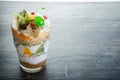 top view on delicious layered fruit and cream dessert in glass