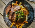 Top view of delicious meal with fresh beef stakes and vegetables in a plate.