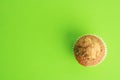 Top view of a delicious muffin isolated on a green background