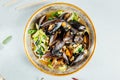 Top view of a delicious noodle soup with veggies and mussels in a bowl on a white surface Royalty Free Stock Photo