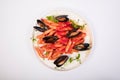 Top view of a delicious pasta meal with tomato sauce, basil and oysters on a white background Royalty Free Stock Photo