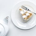 top view of delicious piece of cake with meringue and teapot Royalty Free Stock Photo