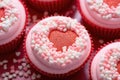 Top view of delicious pink cupcakes with sprinkles and icing in the shape of a heart. Valentine\'s Day dessert to share