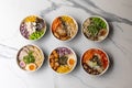 Top view of delicious poke bowls on the marble table