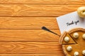 Top view of delicious pumpkin pie, apple and thank you card on wooden orange table.